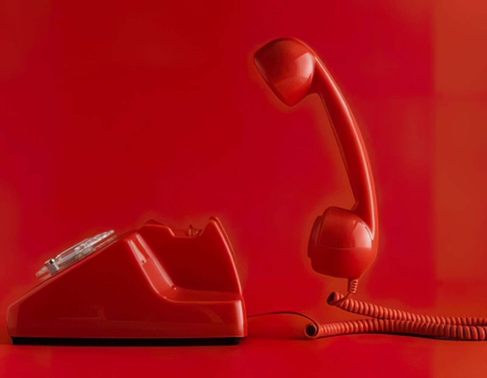 Sculptural red telephone on a red studio set